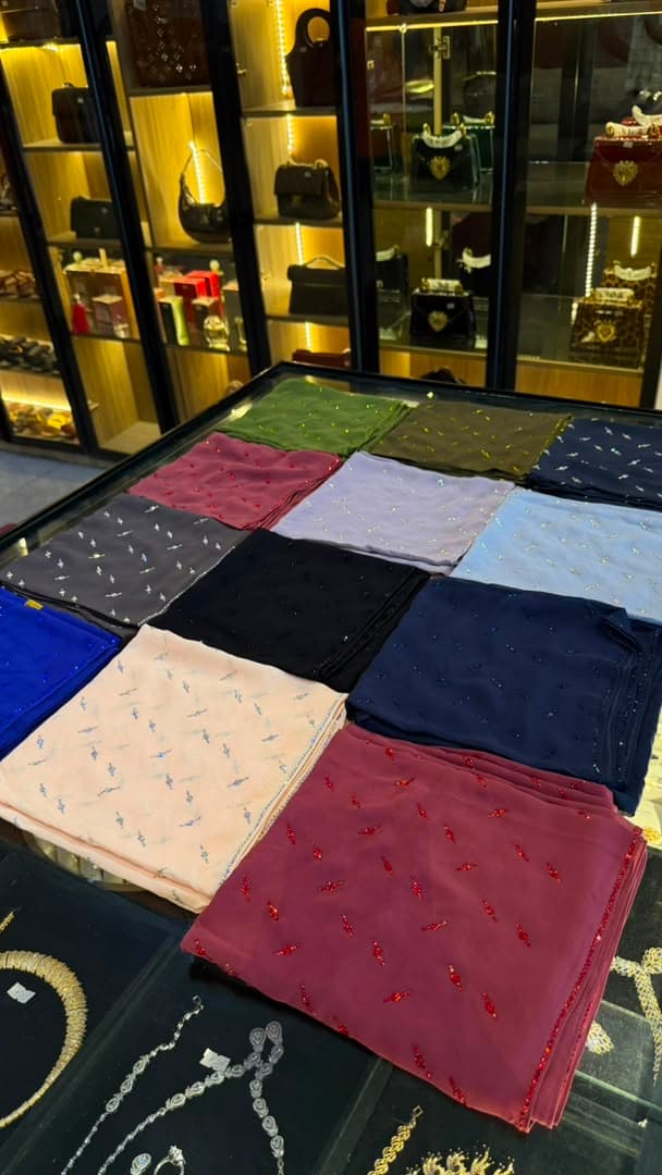 Crystal-scattered chiffon veils in a dozen shades on the boutique counter